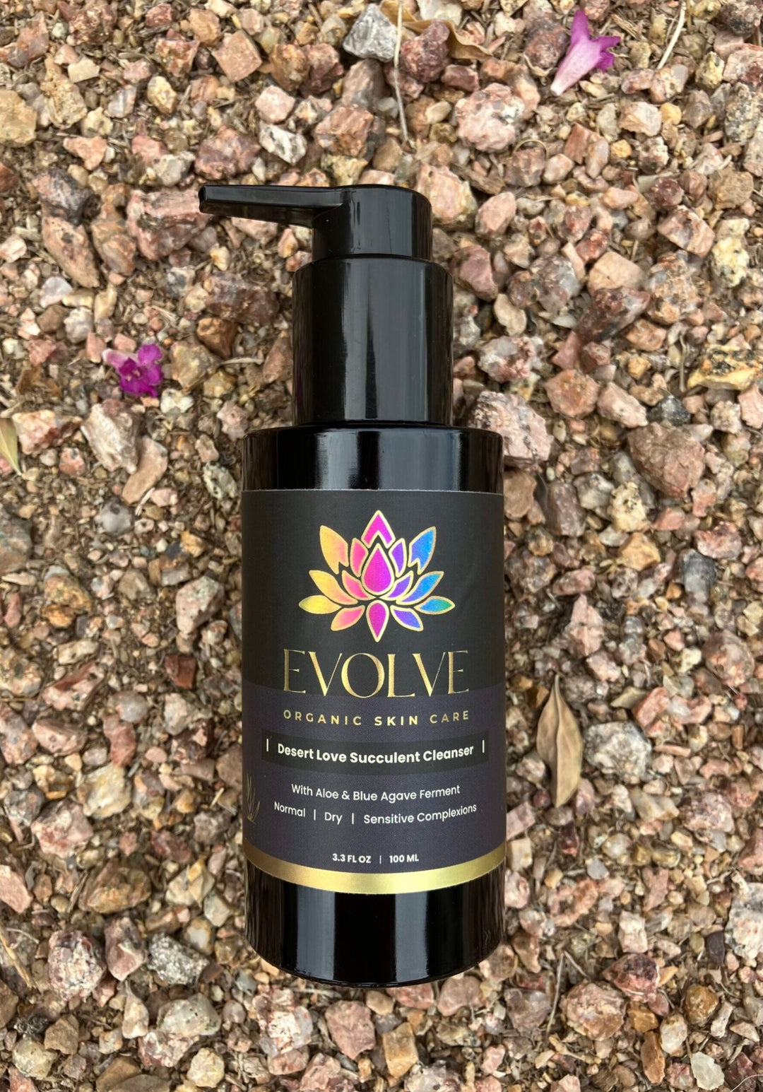 A photo of evolve organic skin care product on a gravel surface