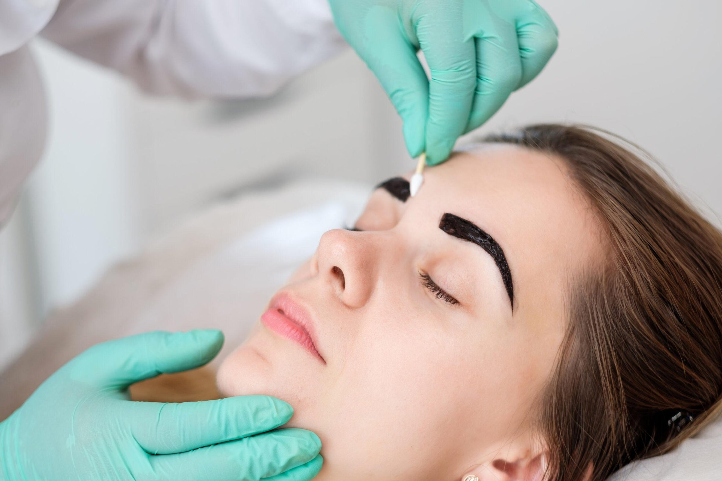 a woman having a brow treatment done