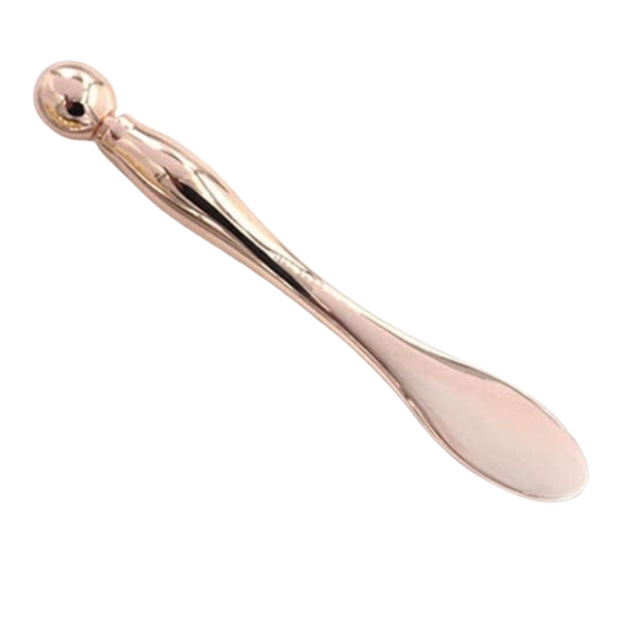A Rose Gold Spatula and Acupressure Tool from Lotus Evolutions